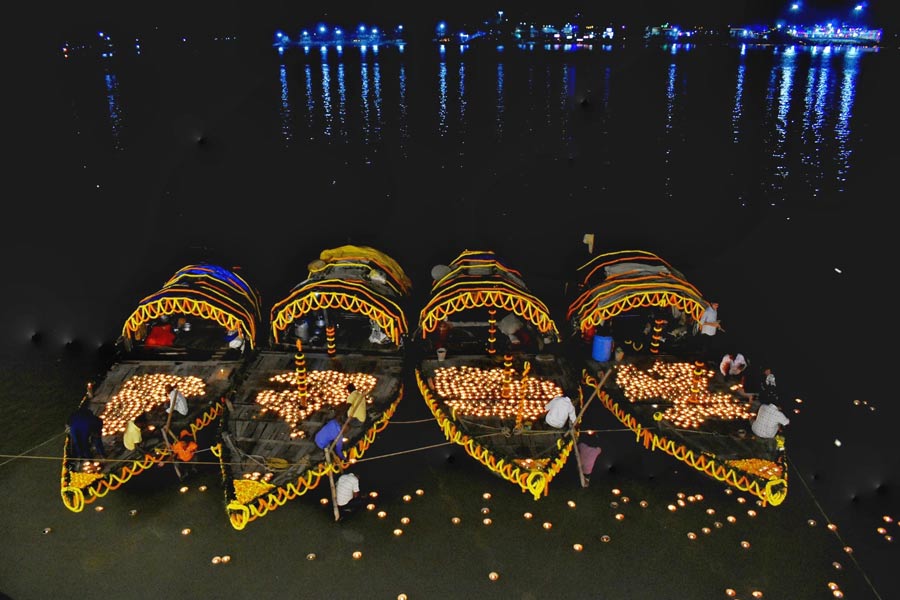 Boats at Salkia Shiv Mandir decorated with diyas on Monday evening for Dev Deepawali 