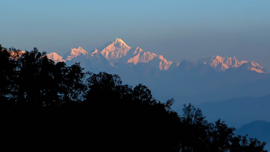 Mount Kanchendzonga range looks different from as seen at Kalimpong as it in the distant horizon with trees in the front and you need a zoom lens for close view