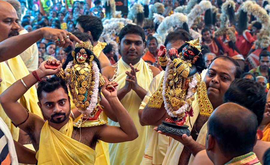 Devotees during the immersion procession of idols of Lord Krishna at the end of "Raas Utsav" at Santipur, Nadia on Thursday  