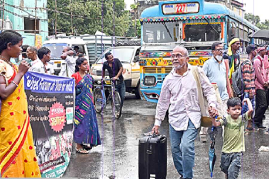 Commuters amid a snarl and a rally in Moulali on Tuesday afternoon