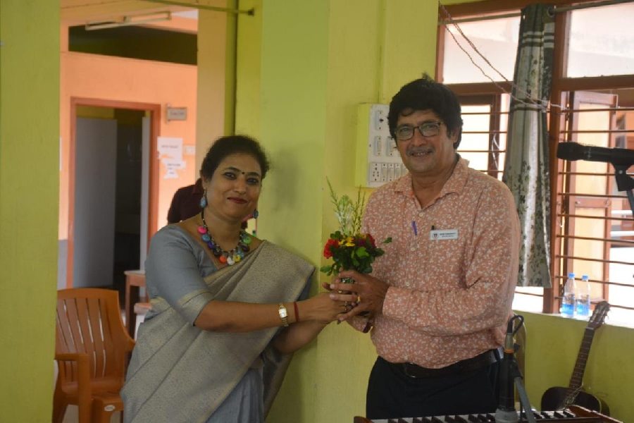 Teacher Joydip Chakraborty is felicitated by the principal of  Apex Academy