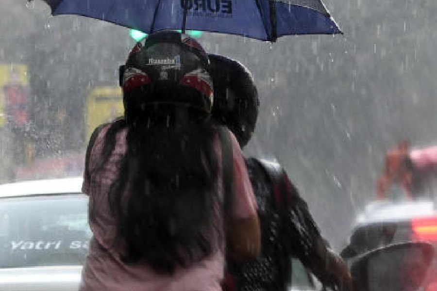 Commuters amid showers in Esplanade on Wednesday afternoon
