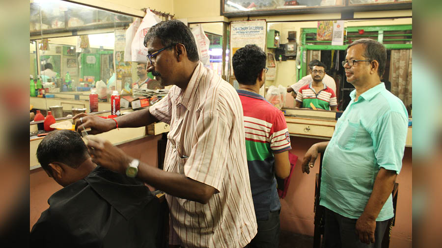 Harinder Thakur (left) and Chandan Deb Sharma (right) have seen the Chitra Saloon transform from a bustling pocket to a silent space