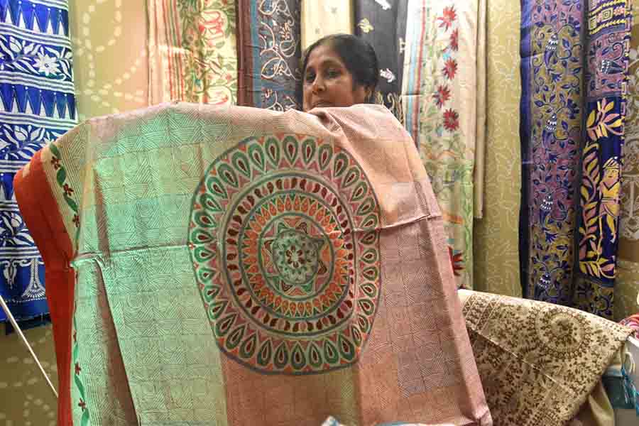 An exhibitor displays her artwork on tussar. Prices of  silk saris at the exhibition start from around Rs.6000 and art silks around Rs 4000. Tussars start from approximately around Rs 6,500 and ‘khesh’ saris with ‘kantha’ work are priced at around Rs1,600. Blouse pieces, kurtas, dupattas, stoles, bags and a variety of other items are also available.
