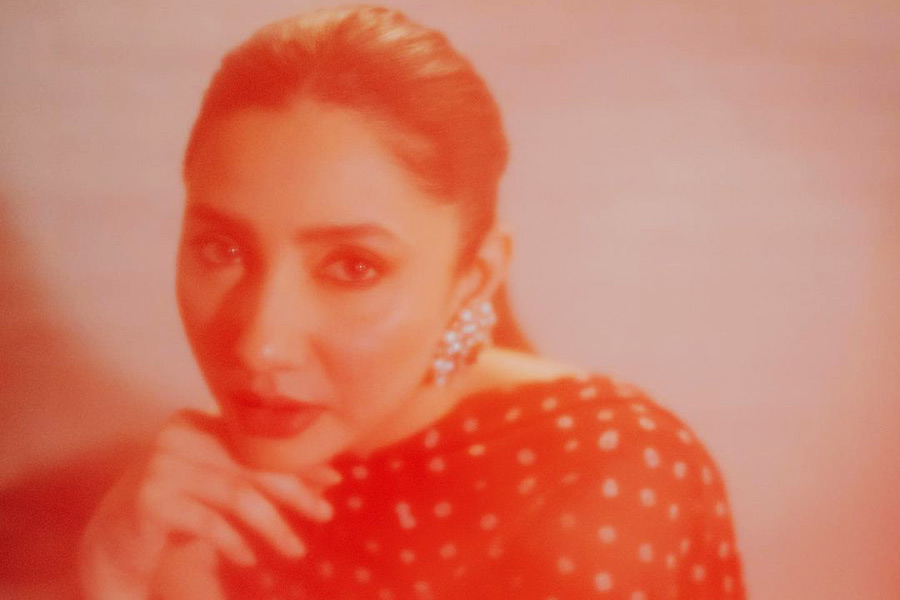 The actress looked stunning in an orange-tinted picture where she unfolded her polka-dotted chunri and wore it over her red-and-white lehenga. 