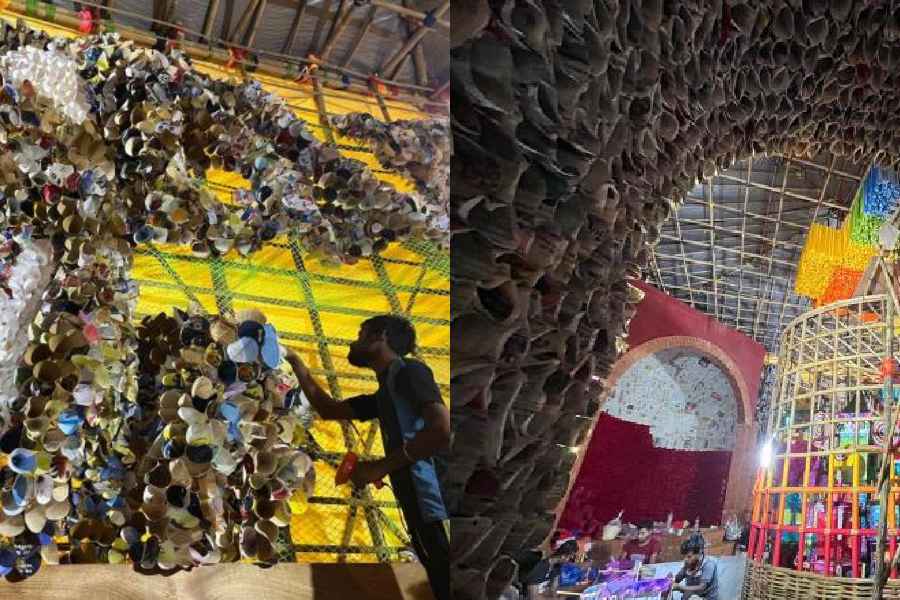 Handmade Tusu-themed artwork is beingput up as part of the grand decorative installation work at Telengabagan Durgotsab pandal