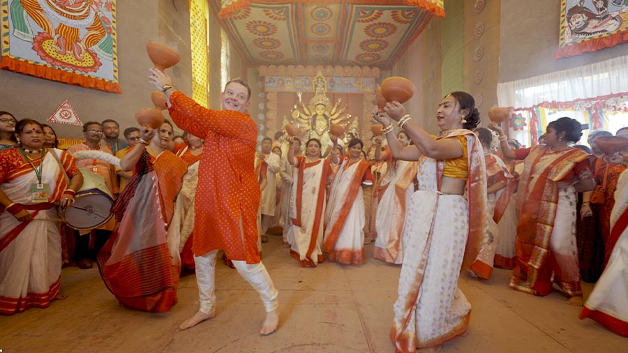Gary Mehigan matching his steps with dancers for a ‘dhunuchi naach’ during Durga Puja