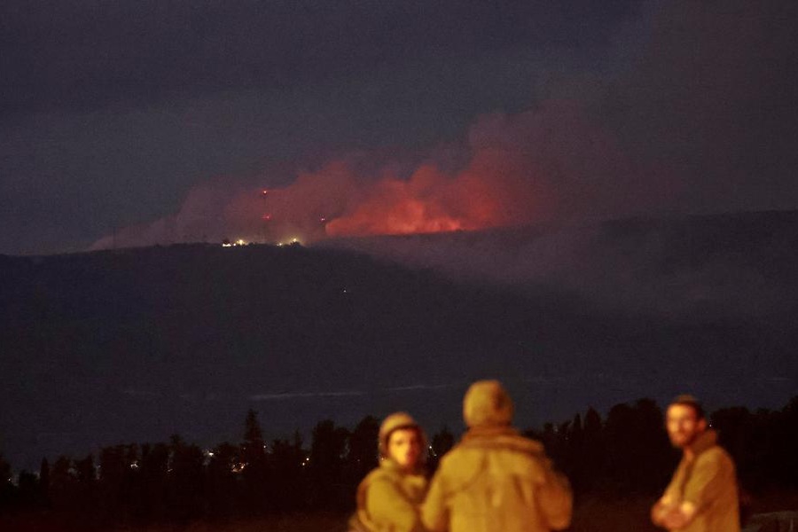Smoke rises and flames burn within Lebanon, as seen from Israel