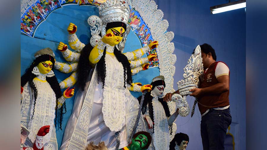 Goddess Durga being put on a silver crown