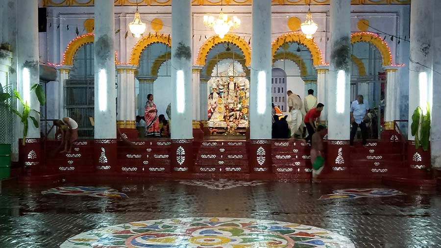 The ‘thakur dalan’ of the family is decorated with ‘alpona’ during Puja