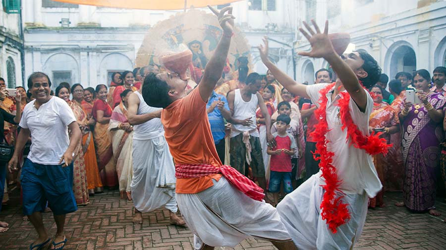 Young men and women of the family take part in ‘dhunuchi’ dance