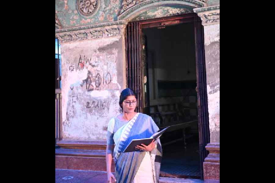Jaya Seal reads out the script in the backdrop of the entrance to Tandon Bari