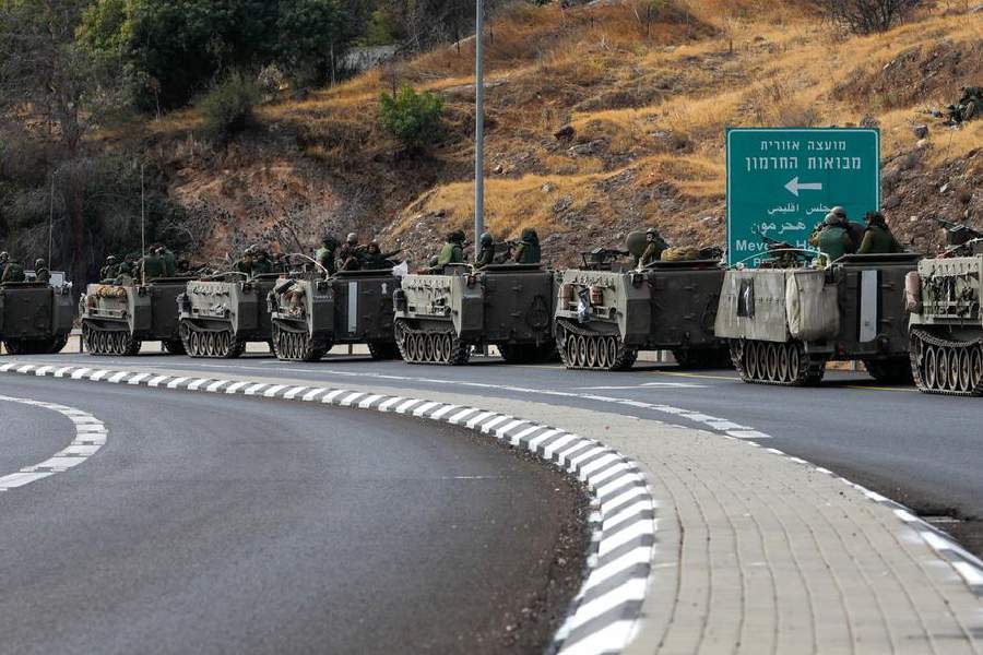 Israeli forces gather on a road near the border with Lebanon