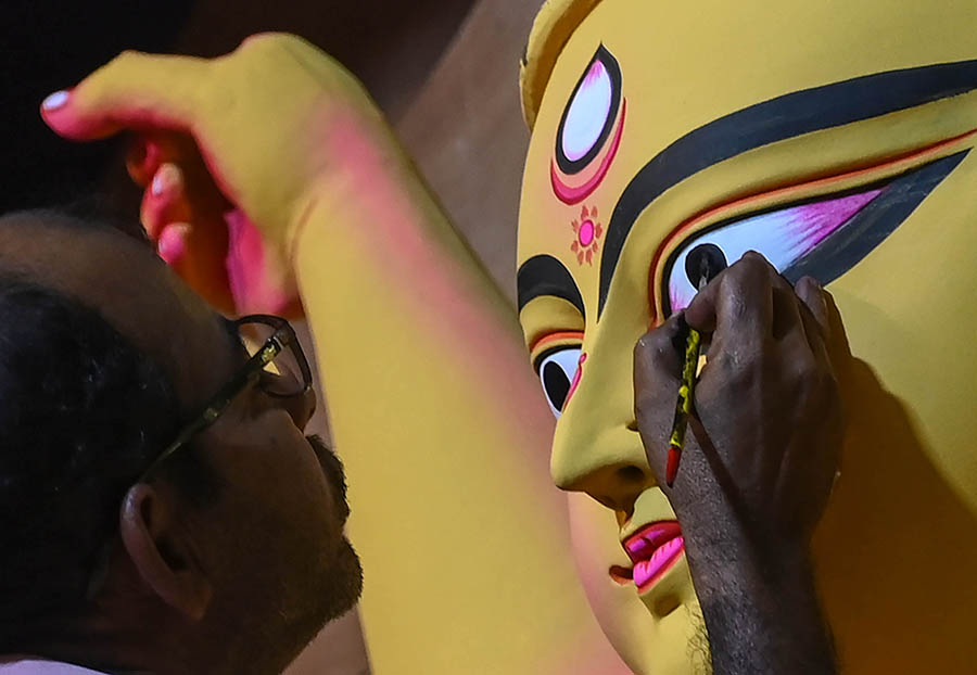 An artist draws the eyes of a huge ‘sabeki’ Durga idol on Friday 