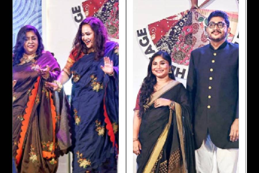 (l-r) With the energetic rhythm of Dugga elo, chamber secretariats Sukanya Bose and Angana Guha Raychowdhury danced their hearts out on the ramp wearing saris by Abhisek Ray. Sumana Sarkar and Abhisek Koar, chamber secretariat members, chose a classic black ensemble and looked party-ready