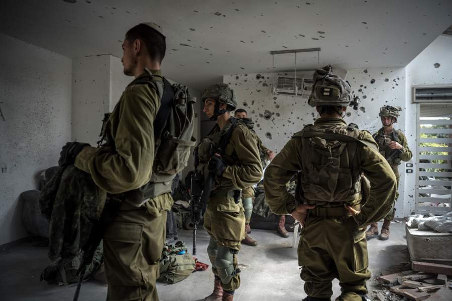 Israeli soldiers inside a house that was overrun by Hamas militants in Be’eri, in southern Israel, on Friday, Oct. 13, 2023. Frightened Palestinians packed belongings and left their homes in northern Gaza on Friday after Israel’s military demanded that more than a million civilians move to the south of the blockaded coastal strip, a possible precursor to a ground invasion but one that the United Nations warmed could be calamitous.