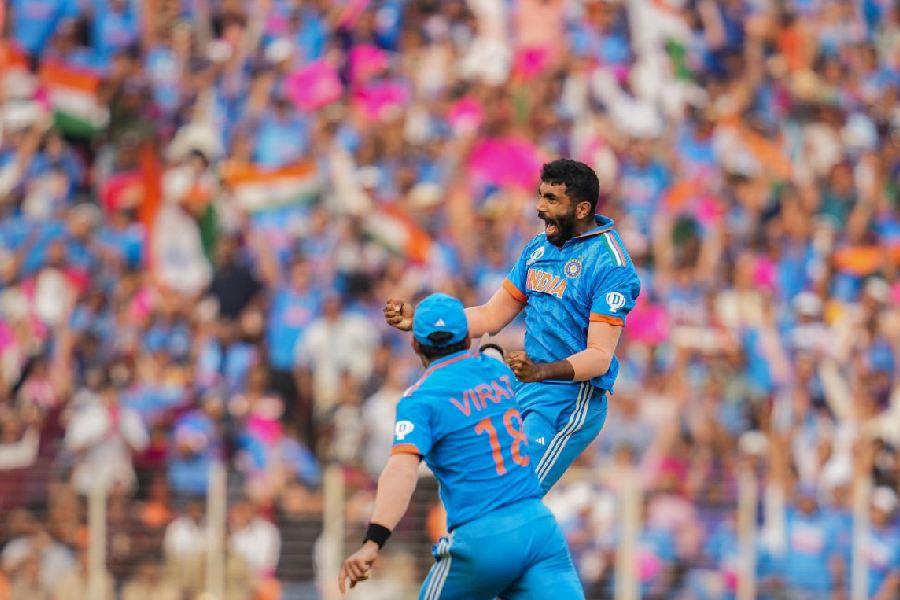 ndia's Jasprit Bumrah celebrates with teammate Virat Kohli after taking the wicket of Pakistan's Mohammad Rizwan during the ICC Men's Cricket World Cup 2023 match between India and Pakistan