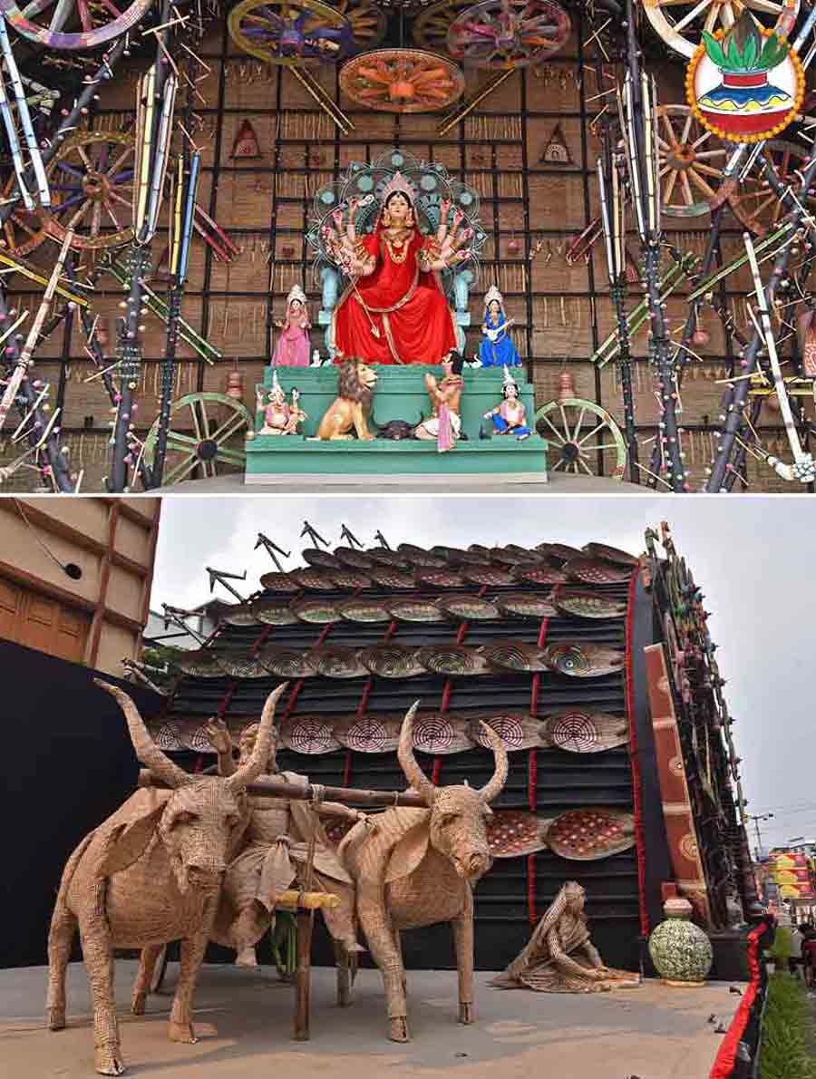 The theme for this year’s Durga Puja pandal at Maniktala Chaltabagan Lohapatty is ‘Ajana Ke Jana’. The pandal showcases a unique atmosphere that celebrates the roots of Durga Puja while embracing the spirit of modern Kolkata. A huge bullock cart adorns the entrance to the pandal, while the main mandap with cart wheels and a myriad other props from rural life in Bengal. The look of the goddess is definitely a showstopper