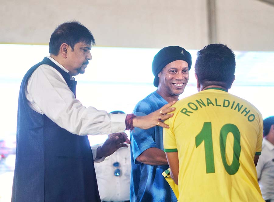A fan greets his hero in a replica of the attacking midfielder’s No. 10 jersey  