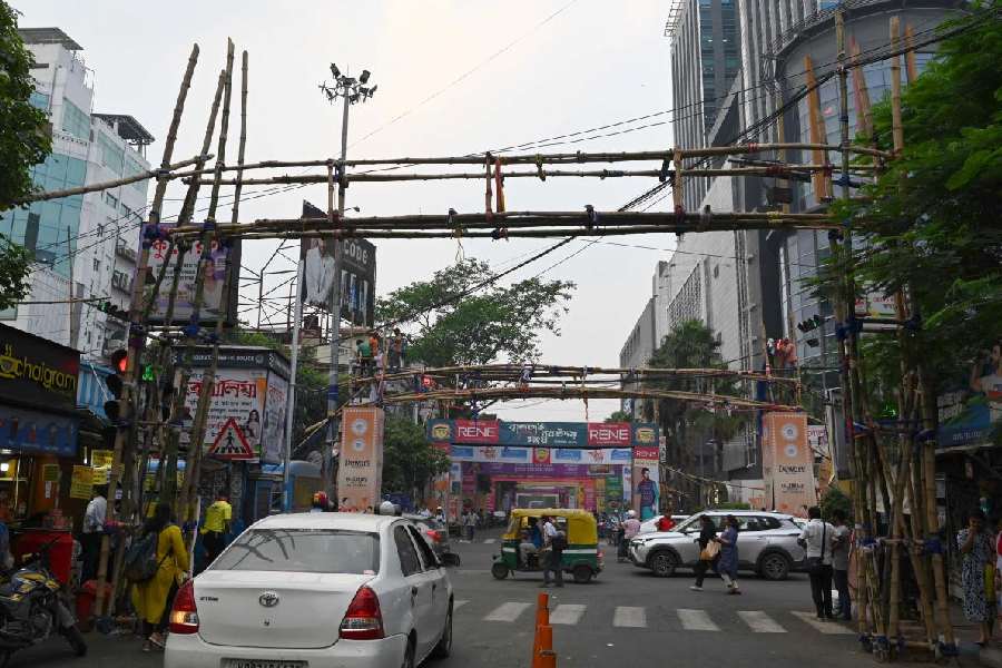 Portions of hoardings that were blocking traffic lights near Acropolis Mall in Kasba being removed on Tuesday. Picture by Sanat Kr Sinha