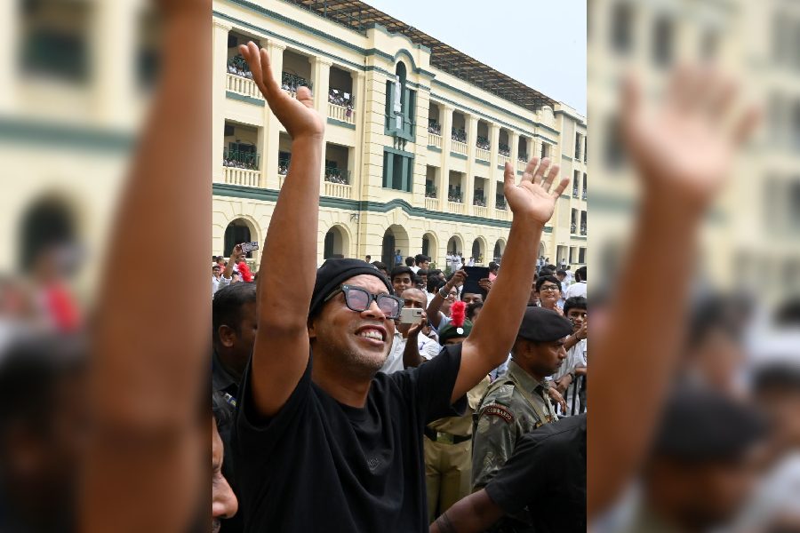 Ronaldinho waves at students and others at St Xavier’s College on Tuesday.