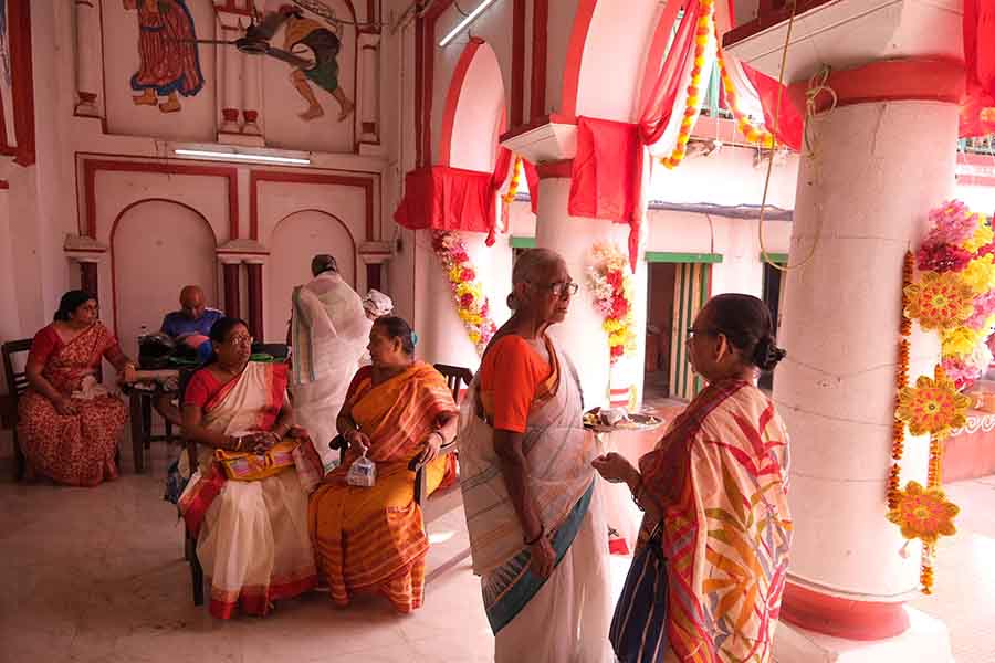 Women come together, sharing tales, laughter, and the heartwarming essence of ‘bodhon pujo’