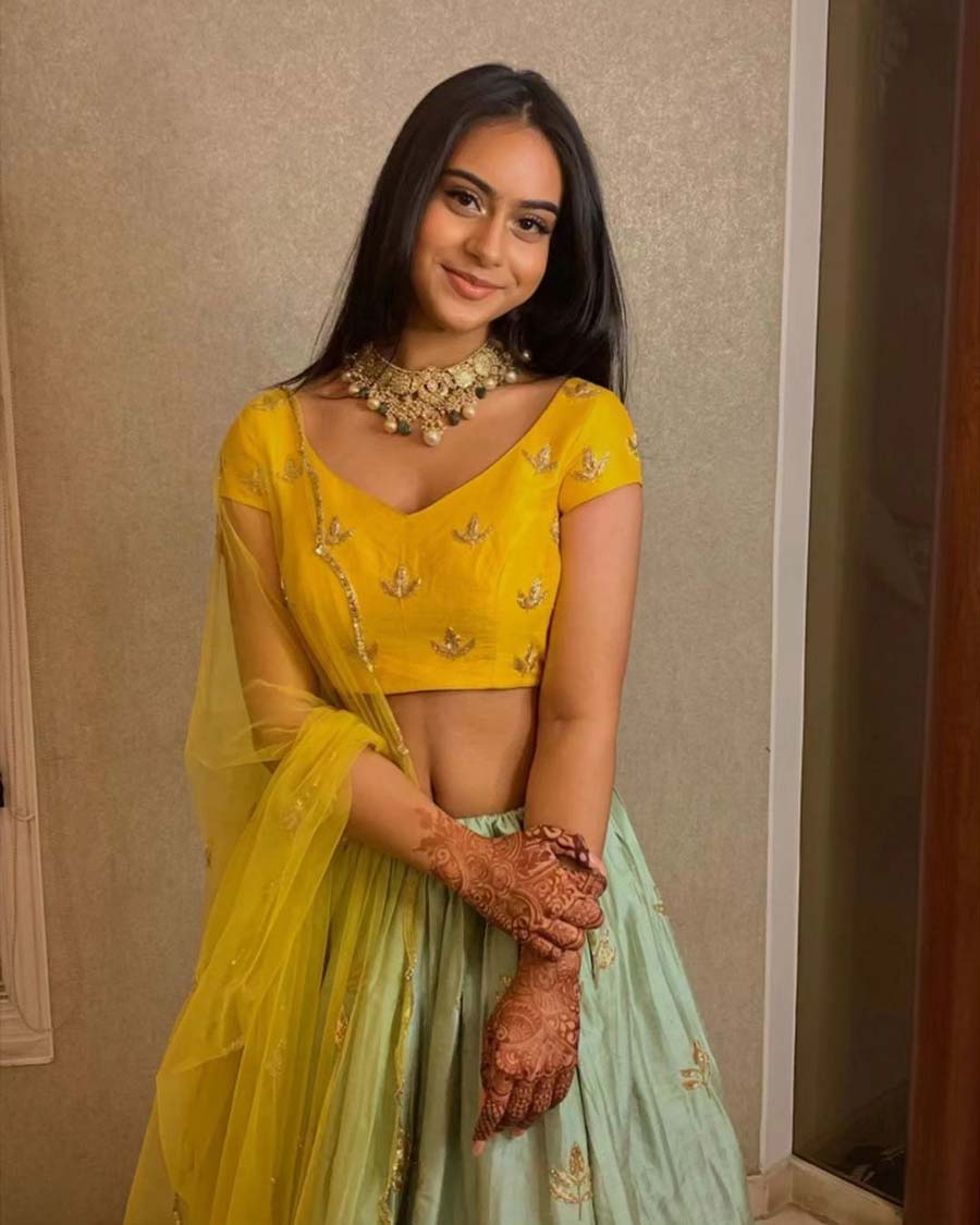 Kajol’s daughter Nysa Devgan keeps it minimal with just a necklace to dress up her sea green ghagra and yellow blouse, paired with a sheer yellow dupatta. 