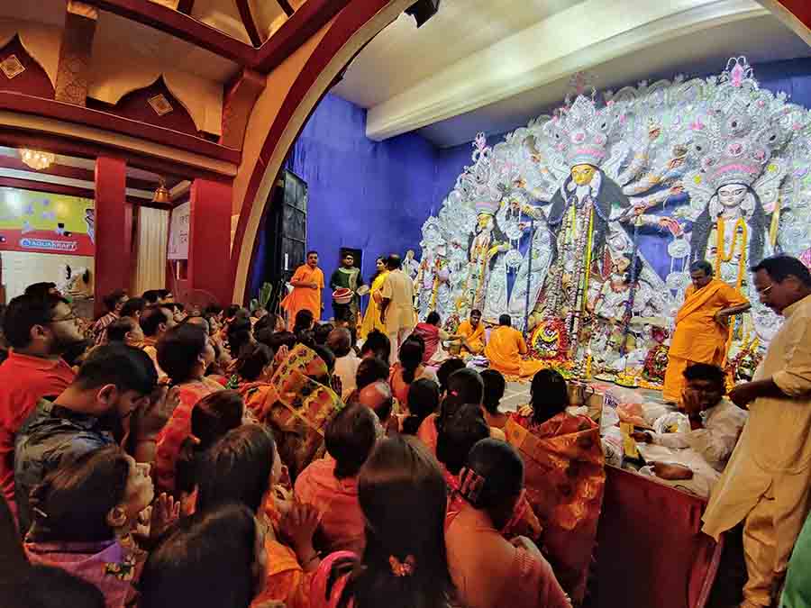 Devotees offer ‘anjali’ at Baguiati Sports Council puja pandal on Sunday morning