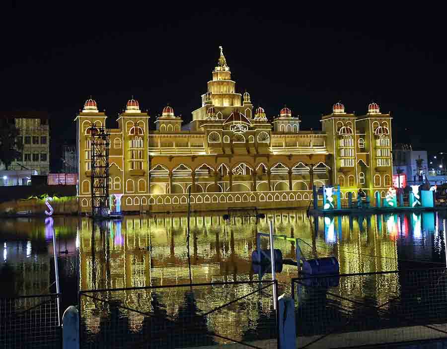 The reflection of the magnificent College Square Durga Puja pandal, which is a replica of the Mysore Palace, falls on water
