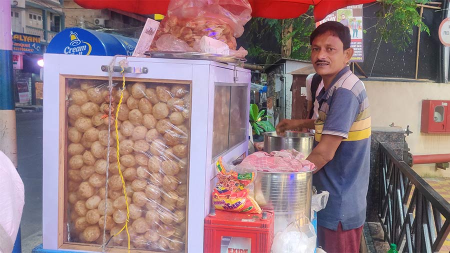 Rakesh Gupta, a phuchka seller from the bylanes of Behala, chooses to set up shop near a puja pandal, hoping to sell more