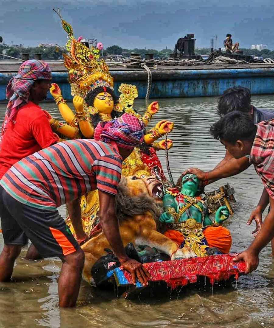 The small puja committees and families gathered at Babughat to immerse their idols in the waters of Hooghly