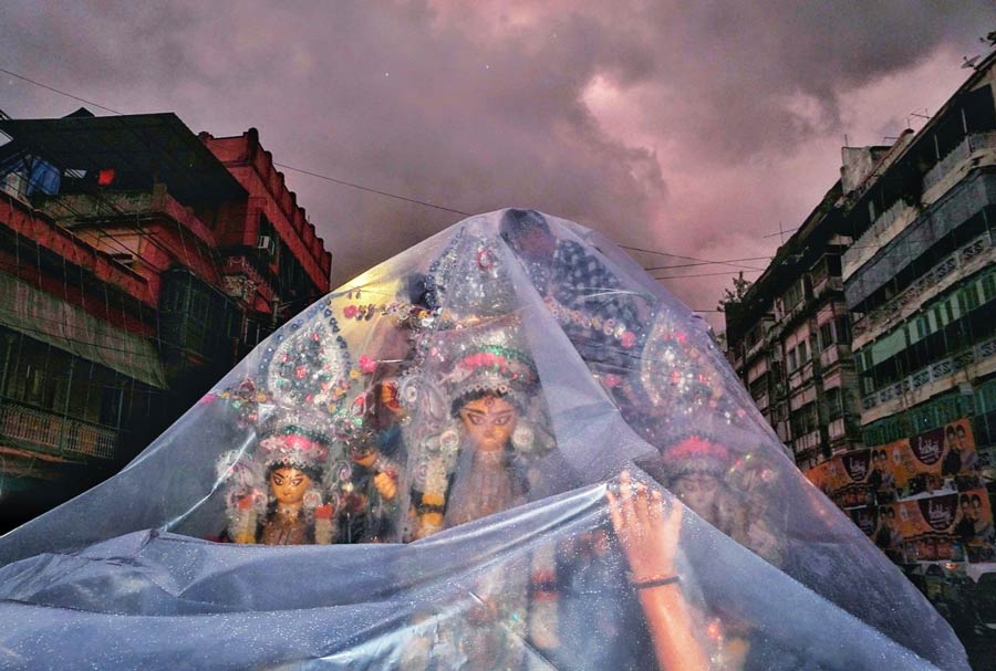 The city received occasional rain on Dashami due to the deep depression in the Bay of Bengal. A Durga idol was covered in plastic on the way to immersion  