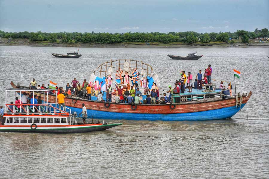 Country boats carry idols of goddess Durga and her children to the middle of the Ichamati river near Taki in North 24-Parganas district. The river has Satkhira district of Bangladesh and North 24-Parganas district of West Bengal on its either sides 