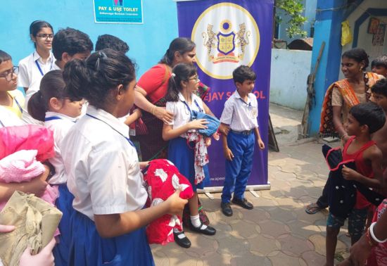 As a part of the social service club activity at Apeejay School, Salt Lake, the students and teachers of the Social Service Club visited a slum area to donate clothes to underprivileged children on the occasion of Durga Puja