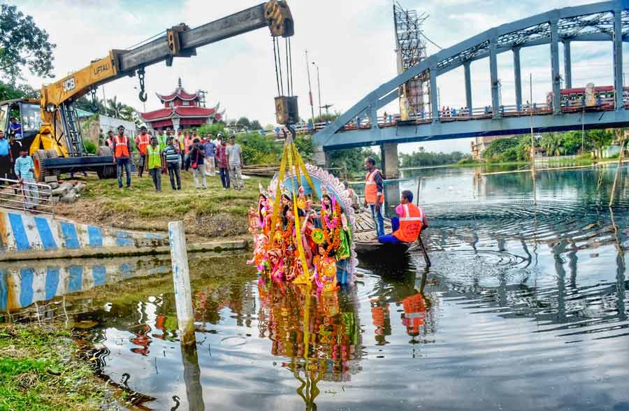 Immersion in the Mathabhanga, which is further upstream of the Ichamati river, at Bongaon was different. As seen on the ghats of the Hooghly in Kolkata, puja materials had to dumped at designated spots, while a mechanical crane was used to lift idols of goddesses immersed in the river to save it from pollution  