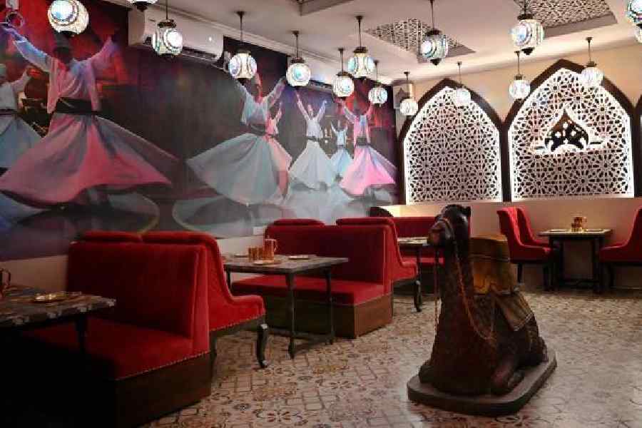 With bright white lights casting an enchanting spell against the backdrop of exquisite art installations resembling Sufi singers, the restaurant emits the perfect vibes of a Middle Eastern soiree. Bright red upholstery adds a bold charm.