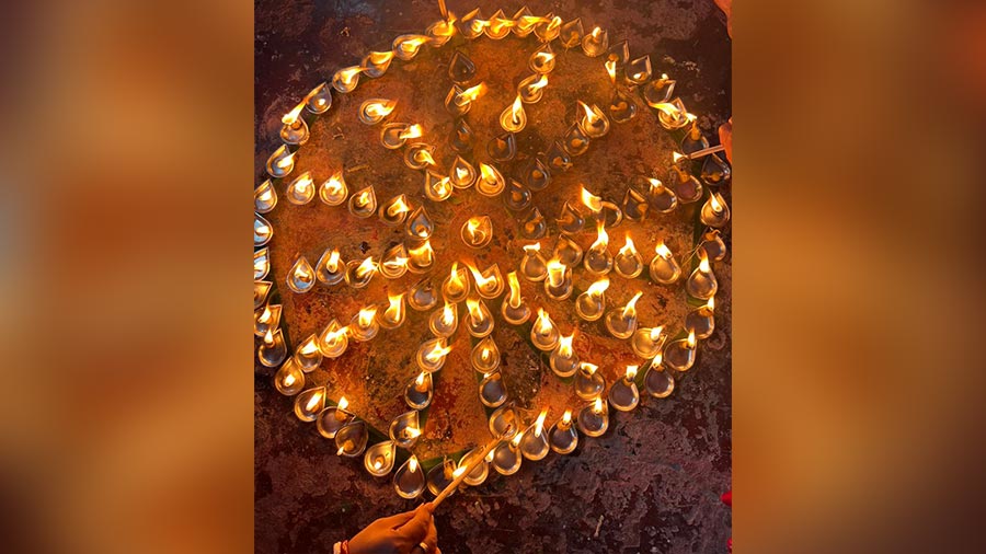 Earthen lamps are lit on the eve of Kali Puja at the Ghoshes 