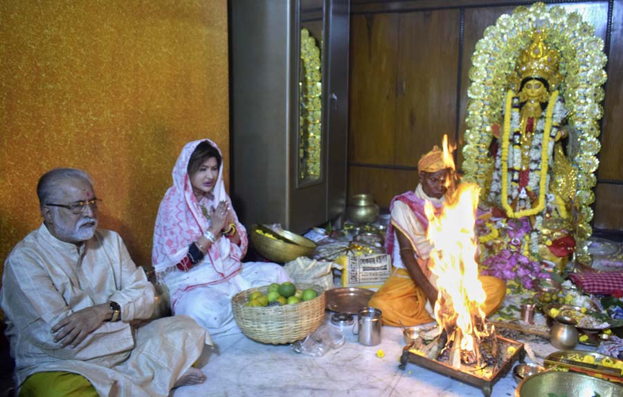 Politician Sudip Bandyopadhyay and his wife Nayana pray at the puja in their house on Saturday