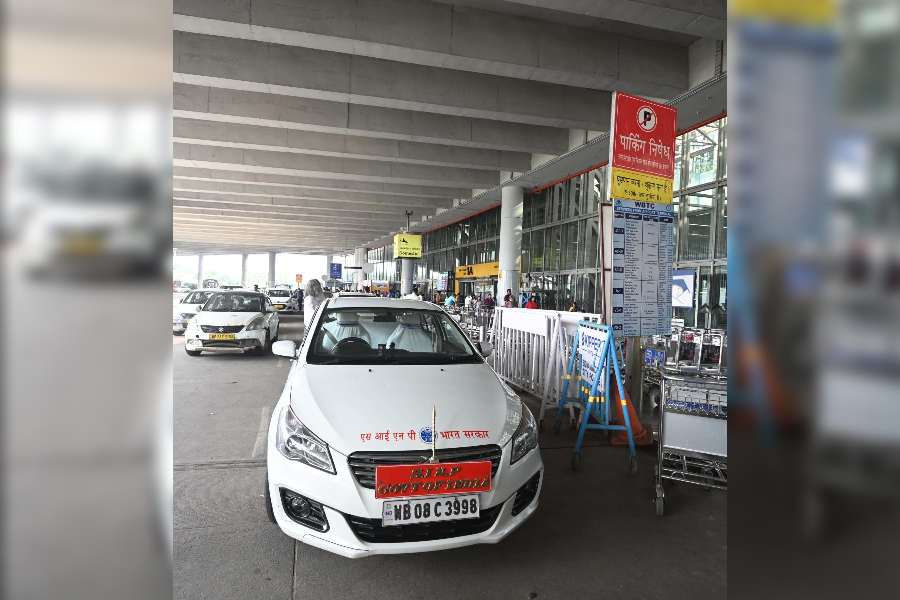 A car with a "Govt of India" board parked in front of a no-parking sign outside the Calcutta airport terminal on Sunday. It was parked there for at least an hour.