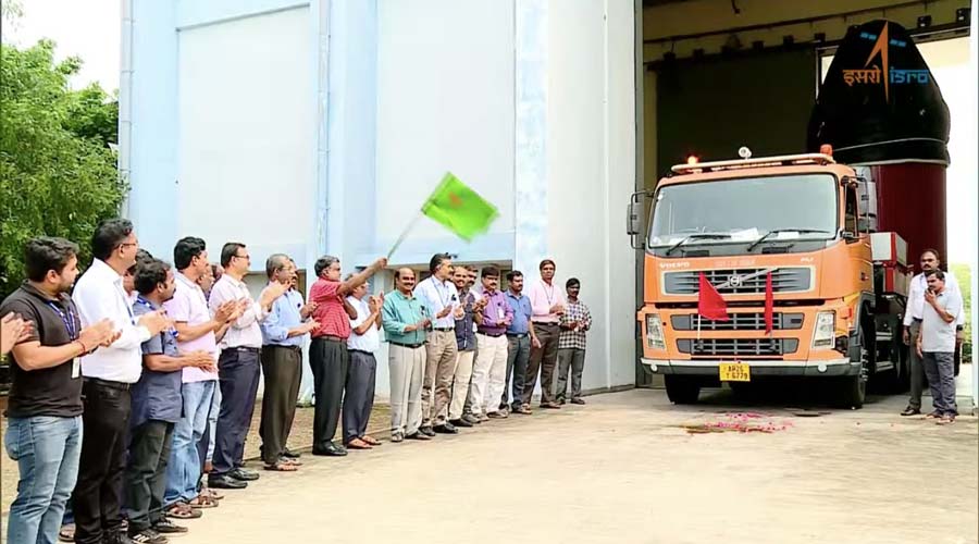 Isro scientists and other employees applaud as the rocket makes its way to the launch pad