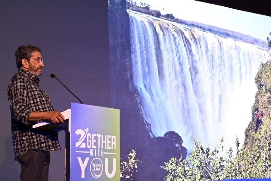 Actor Sabyasachi Chakraborty shows a picture he took of Victoria Falls, the spectacular waterfall located about midway along the Zambezi river, at the programme at a city hotel on Saturday