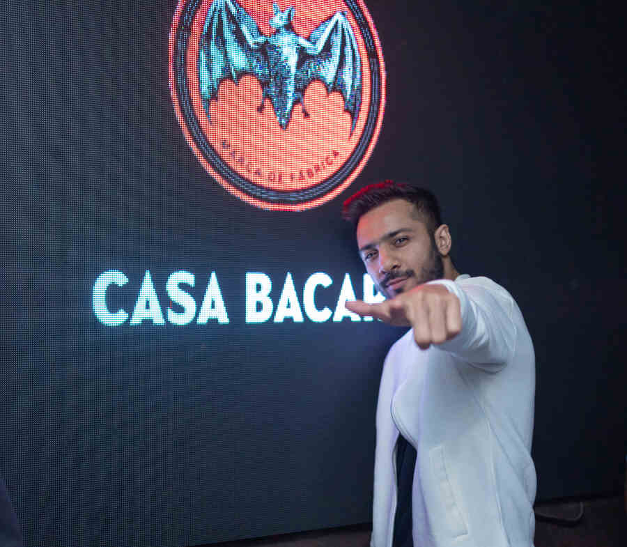 In the middle of his set, DJ Omen paused to strike a pose in front of the Bacardi logo