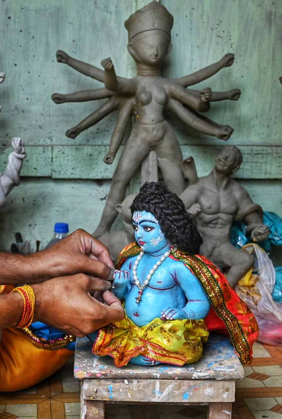 Ahead of Janmashtami, an artisan gives finishing touches to an idol of Gopal at Kumartuli on Tuesday 
