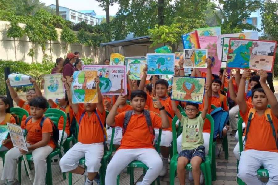 Children showcase their handmade posters during a green drive conducted by SIP Abacus at BT Road