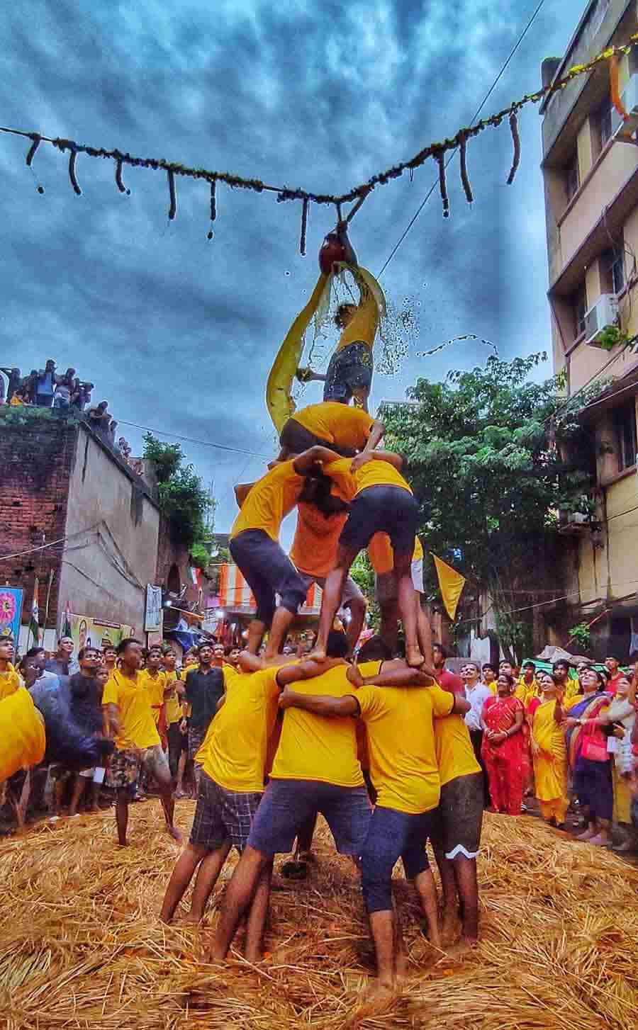 People take part in a dahi handi-breaking ritual at Pathuria Ghat Street in north Kolkata on Janmashtami on Thursday