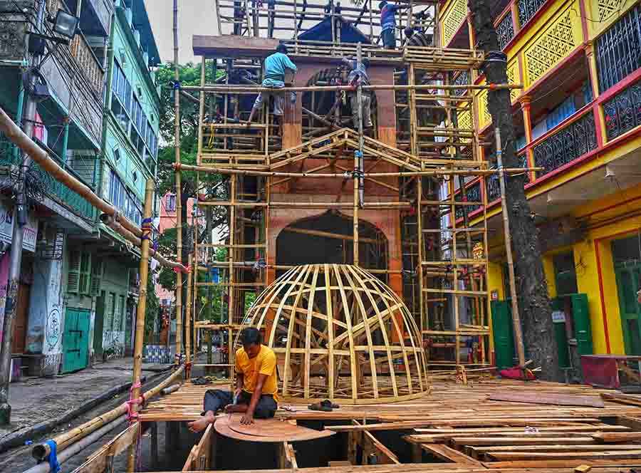 With barely 43 days left for Durga Puja festivities to start, workers toil round-the-clock in constructing a puja pandal in north Kolkata 