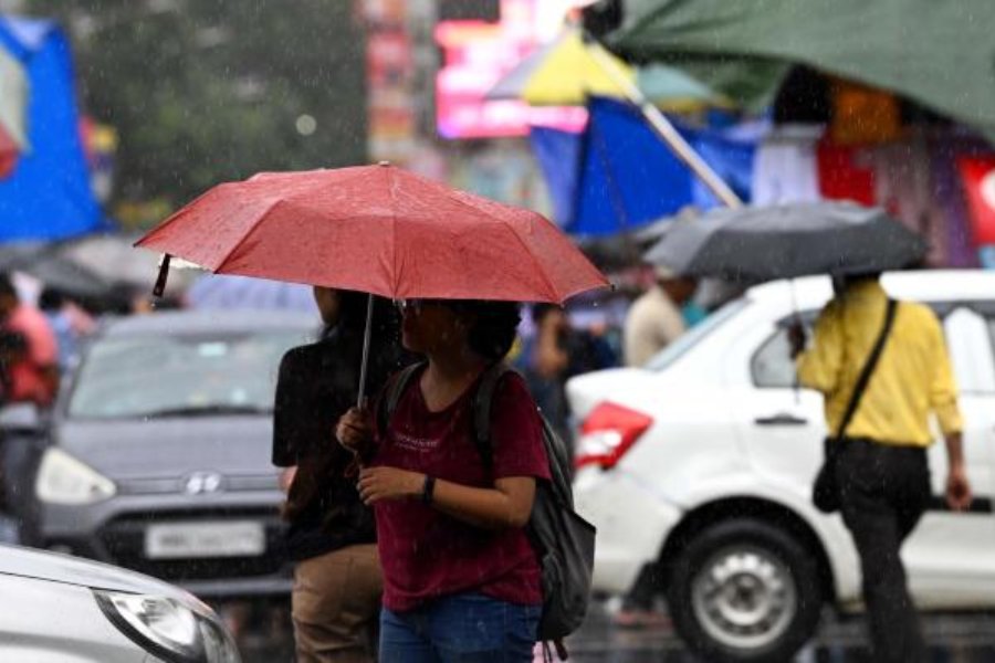 Pedestrians amid rain on Chowringhee on Thursday afternoon