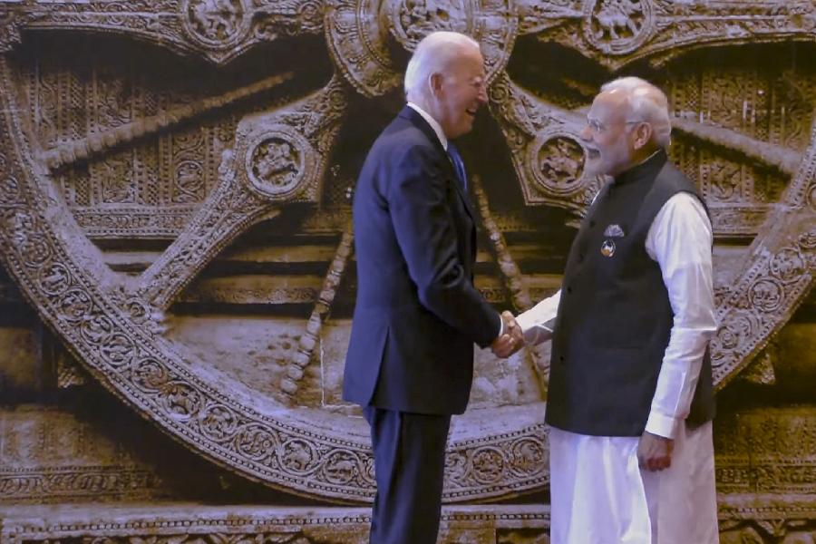 PM Modi welcomes US President Joe Biden on his arrival for the G20 Summit. He later explained the history of the Konark Wheel, a replica of which is serving as the backdrop, to him.