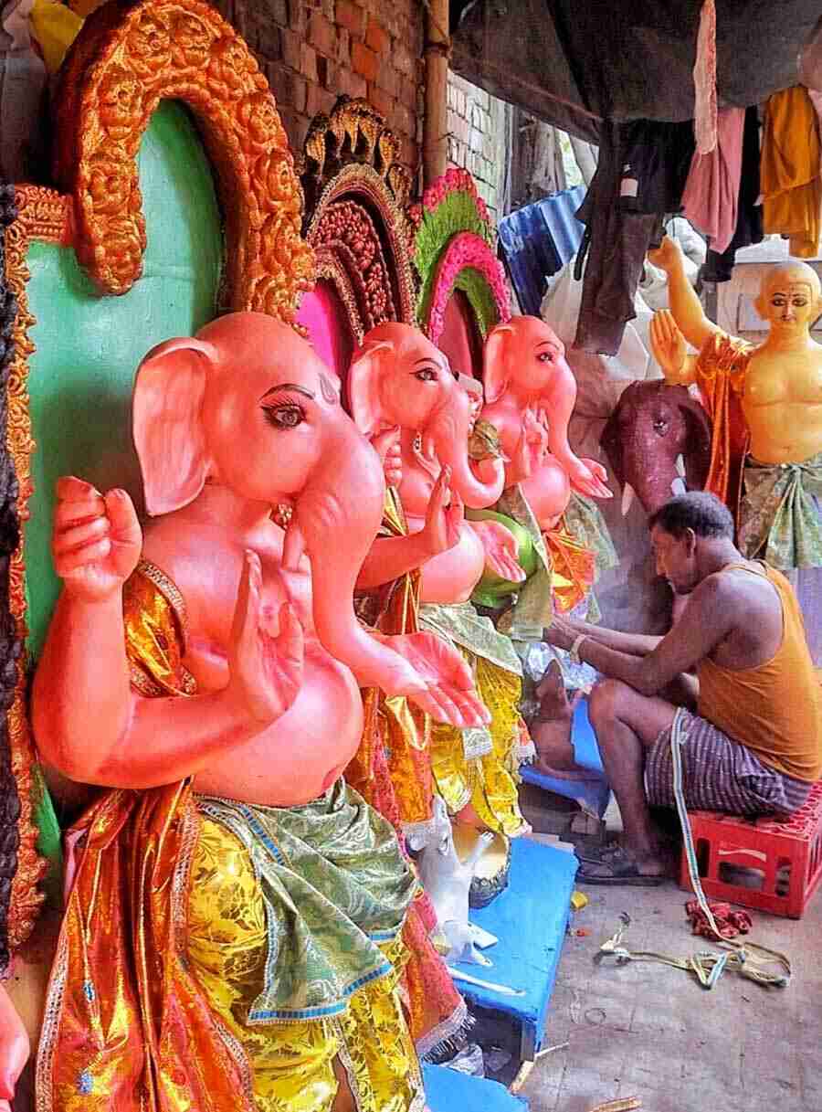 An artist gives finishing touches to a Ganesh idol at Patuapara on Monday afternoon a week ahead of Ganesh Chaturthi 