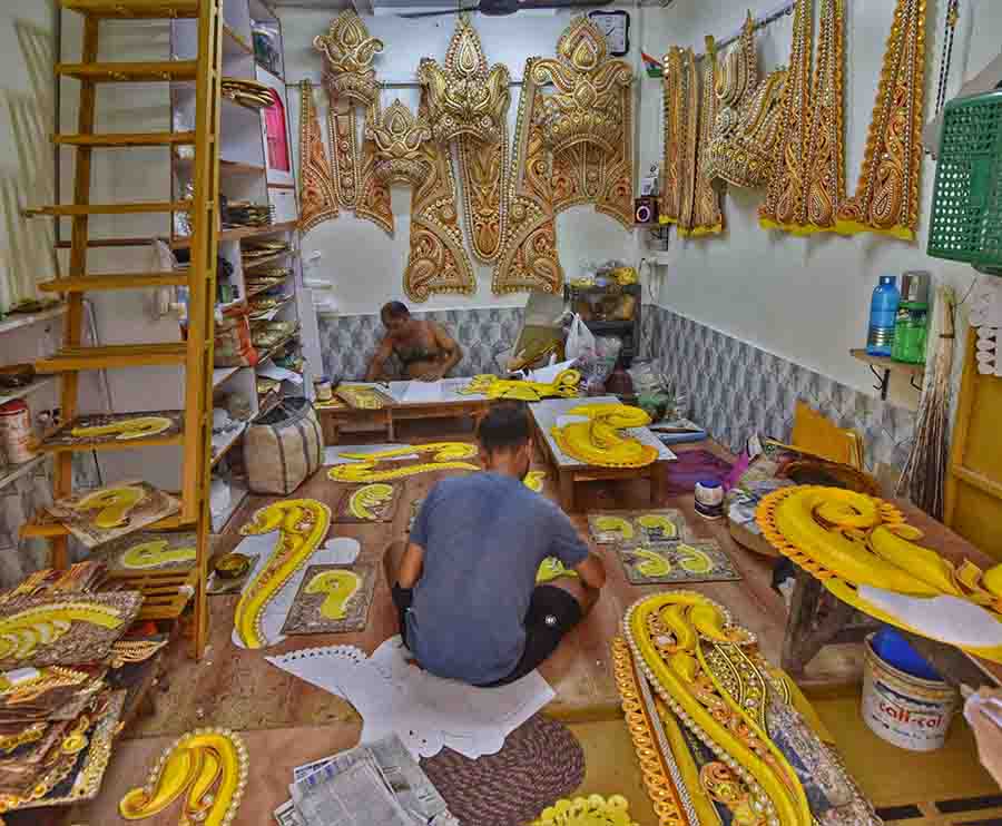 Artisans busy making ornaments and headgears for Durga idols at Kumartuli  